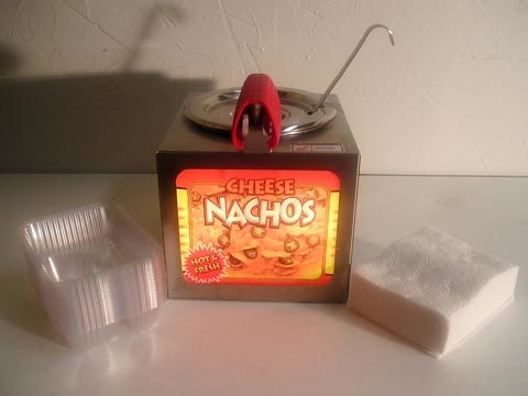 Nacho Machine..includes 1 Can of Nacho Cheese..2 Bags of Nacho Chips.and 50 Nacho Trays